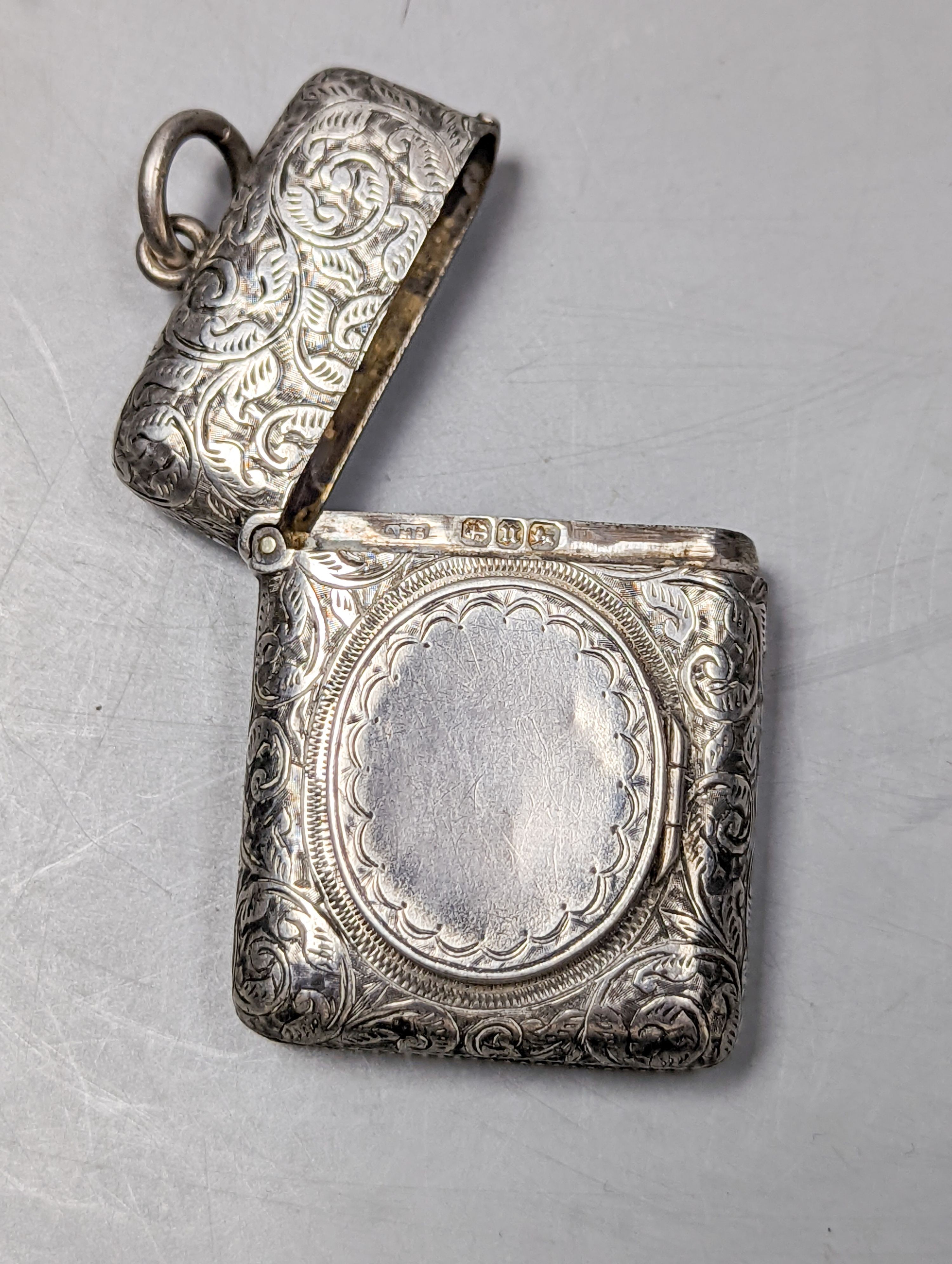 A late Victorian engraved silver vesta case with locket compartment, Abraham Meyer Blanckensee, Birmingham, 1894, 49mm.